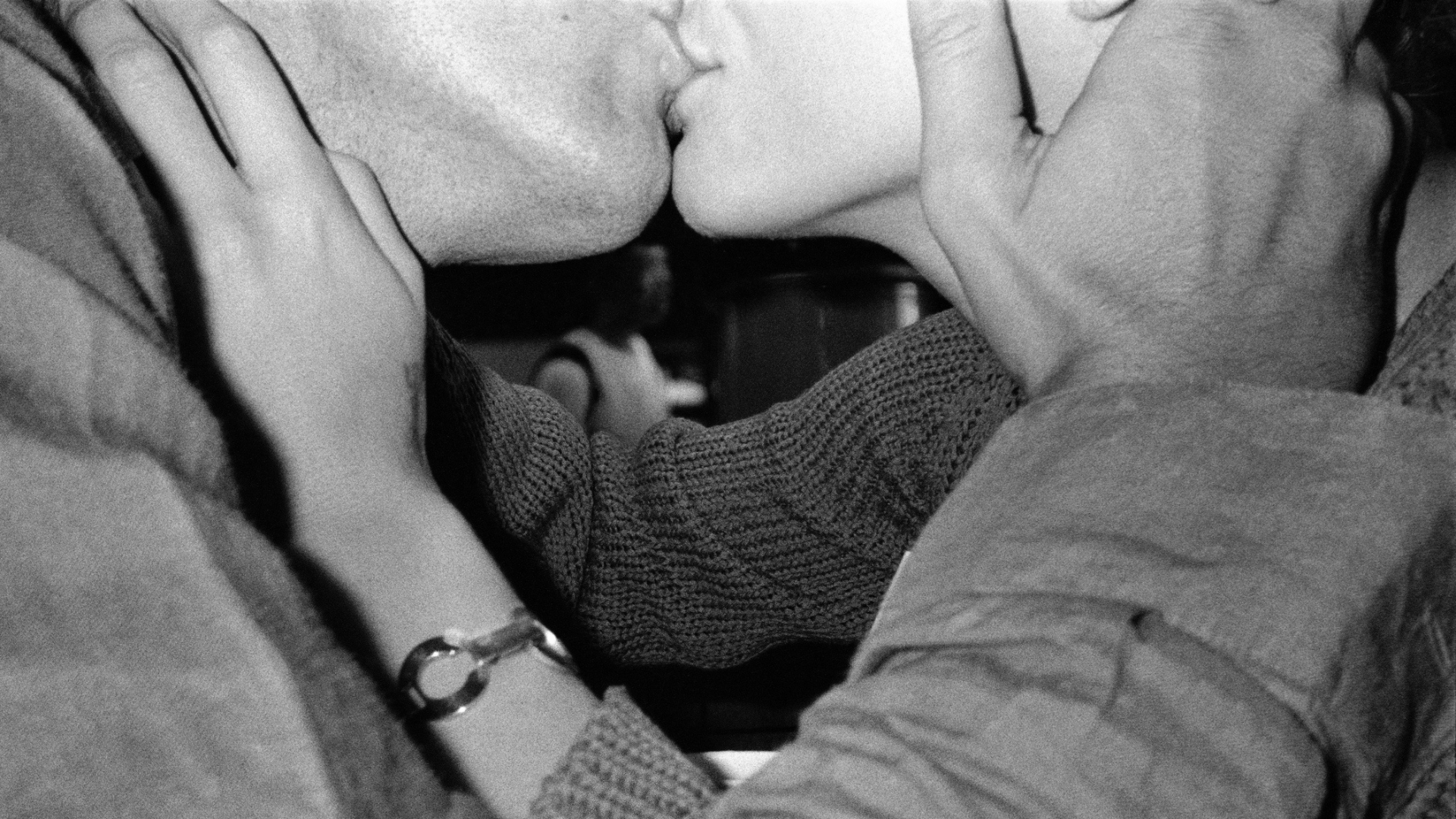 black and white photo of a couple kissing (story: dirty talk guide how to)