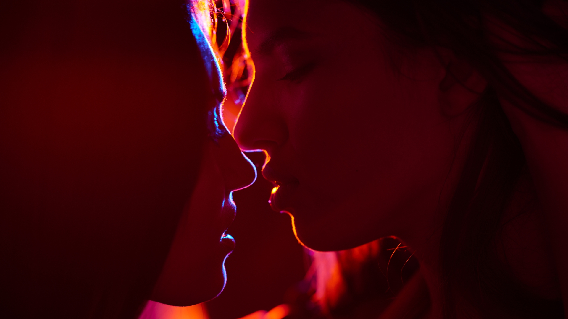 couple kissing in red lighting edging